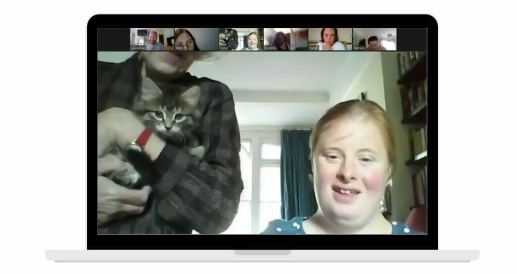 Chloe shows her cat to the group over zoom.