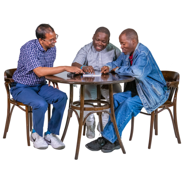 3 people talking together around a table.