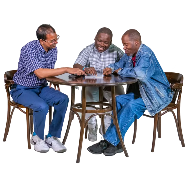 3 people talking together around a table.